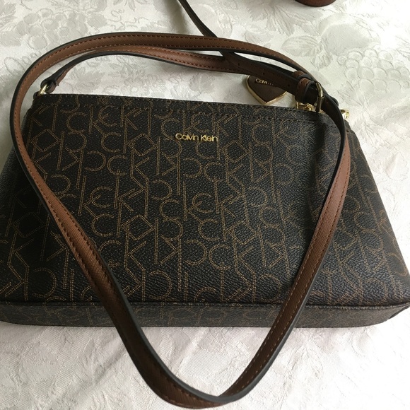 Calvin Klein Handbags - NWOT Calvin Klein brown shoulder bag with adjustable strap and logo charm